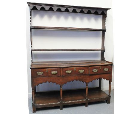 EARLY 19TH CENTURY WELSH OAK POTBOARD DRESSER, having moulded cornice over shaped frieze to the two shelf, open rack back, th