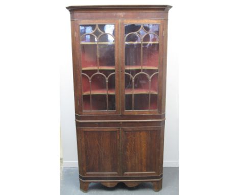 19TH CENTURY WELSH OAK DOUBLE CORNER CUPBOARD, having moulded cornice over mahogany veneered frieze, a pair of glazed doors w