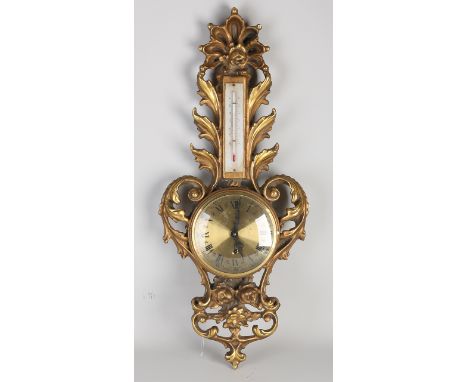 Italian gilded wooden barometer clock.&nbsp;Neo baroque.&nbsp;Circa 1960. Size: 68 cm.&nbsp;In good condition.