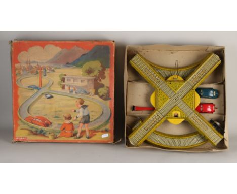 German tin toy racing track from the 1930s.&nbsp;In original box DRP Perry.&nbsp;Consisting of two cars, race track and traff