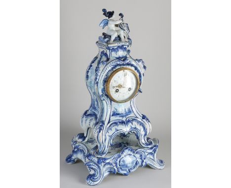 19th century Delft Fayence mantel clock on console.&nbsp;Rococo style.&nbsp;Console is neat.&nbsp;Clock and dial are glued.&n