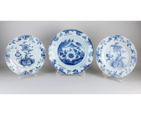 Three large 18th century Delft Fayence dishes with floral decoration.&nbsp;Twice with bottom mark.&nbsp;Light edge damage.&nb