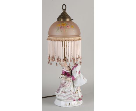 Porcelain figural table lamp with glass lampshade.&nbsp;20th century.&nbsp;Dimensions: H 48 cm.&nbsp;In good condition.