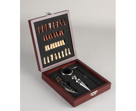 Hardwood miniature chess set with corkscrew, wine stopper and thermometer.&nbsp;21st century.&nbsp;Size: 5 x 17 x 15 cm.&nbsp