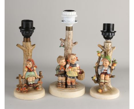 Three old German Hummel lamp bases.&nbsp;One lamp chip (bottom edge).&nbsp;One lamp glued.&nbsp;One lamp good.&nbsp;Dimension