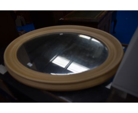 A vintage oval wall mirror