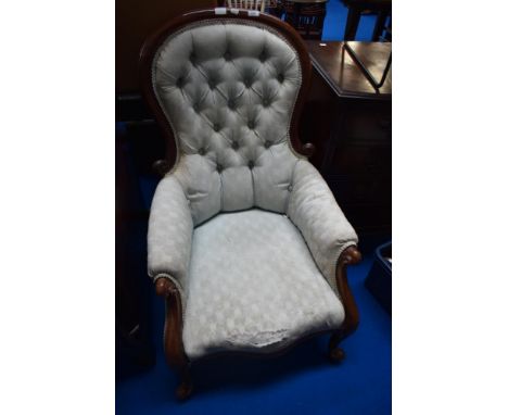 A Victorian spoonback chair having scroll arms and later light green button back upholstery
