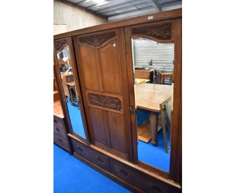 A Victorian oak triple wardobe having two mirror doors, approx dimensions W168 D49 H190cm, does split for ease of transport&n