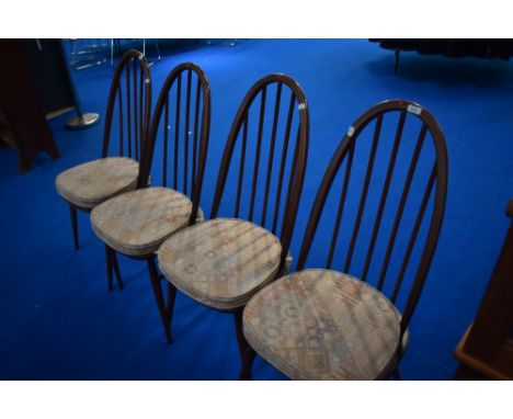 A set of four tradtional dark stained Ercol high hoop and stick back kitchen dining chairs