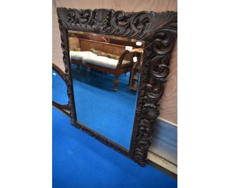 A 19th Century wall mirror having oak foliate frame, approx. 111 x 89cm