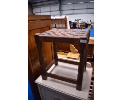 An Arts and Crafts leather lattice top stool, having adzed frame, similar in style to Mouseman but more likely to be Stanley 