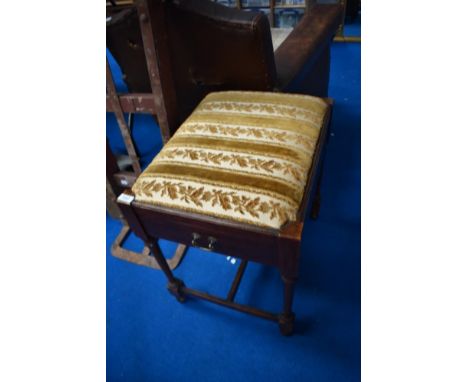 A late Victorian mahogany piano stool having drawer storage for sheet music , and later upholstered seat