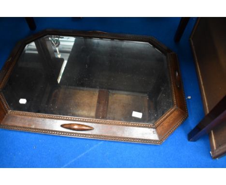 An early 20th century oak canted wall mirror