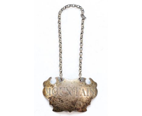 A George III silver bottle ticket, c.1760, incised MOUNTAIN, maker and lion passant only, 5cm, 11gm. Mountain is a sweet dess