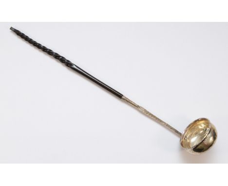 A George III silver and whalebone toddy ladle, 1711 coin insert feather edge border, 36cm 