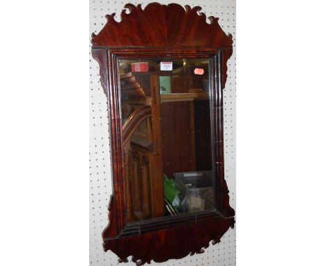 A 19th century mahogany Chippendale style fret carved rectangular wall mirror, having a cushioned moulded inner slip, 75 x 41