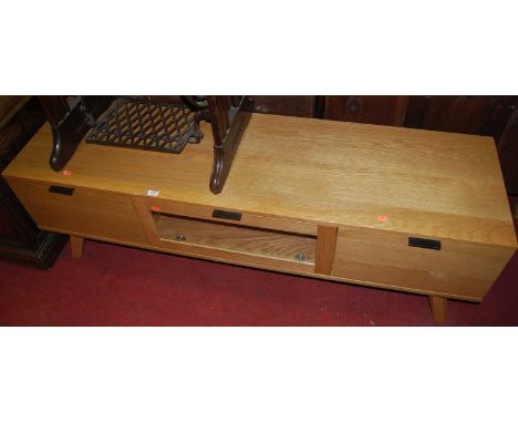A contemporary light oak low media unit, w.150cm