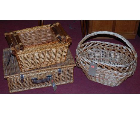 Contemporary wicker wares, to include; a picnic hamper (lacking contents), three graduated carrying baskets, and a single han