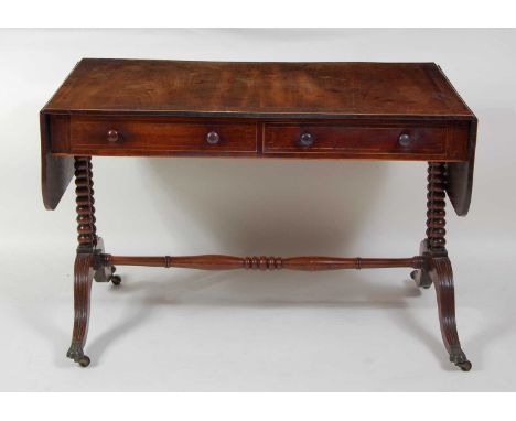 A Regency mahogany and rosewood crossbanded sofa table, having single real and single dummy drawer to either side, the whole 