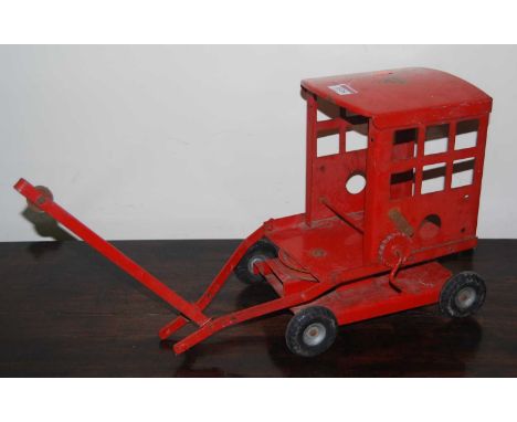 A Triang Toys large-scale pressed steel model of a four-wheel crane, finished in red (a/f)