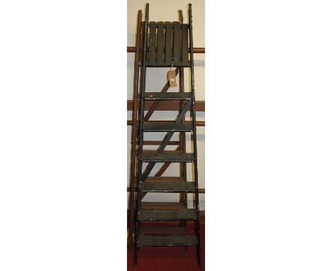 A stained wood hinged decorator's ladder; together with a matching black painted example (2)
