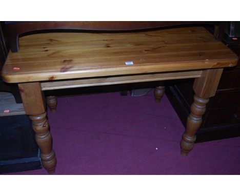 A modern pine round cornered kitchen table, raised on turned supports, length 106cmCondition report: Some light scratches to 