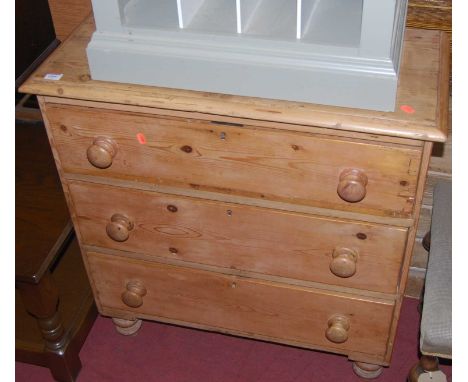 A Victorian pine chest of three long drawers, having turned knob handles and raised on turned squat supports, w.79cmCondition