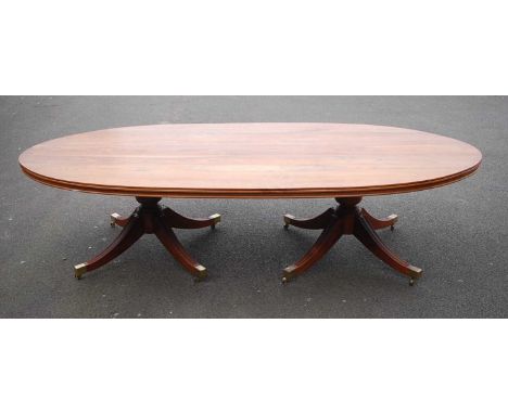 A Canadian walnut twin pedestal dining table, in the Regency style; together with ten matching dining chairs, as manufactured