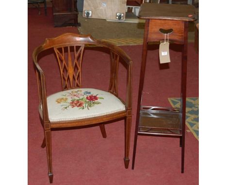 An Edwardian mahogany two-tier plant stand; together with an Edwardian mahogany and satinwood strung tub elbow chair with tap