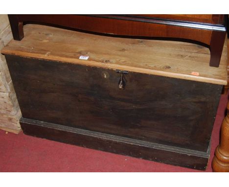 A stained pine plank topped hinged tool chest, having iron end carry handles, w.85cm