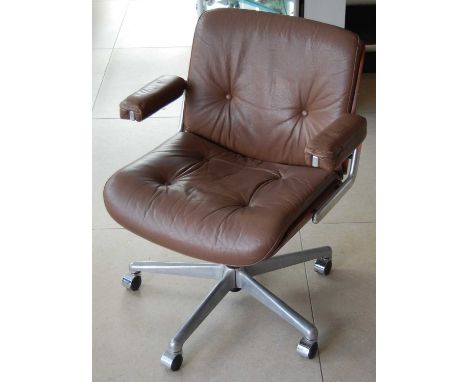 Gordon Russell - a 1960s brushed aluminium, plywood and tan leather upholstered swivel desk elbow chair, raised on roller cas