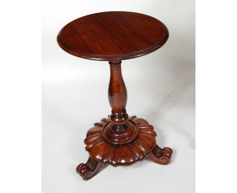 A William IV rosewood pedestal lamp table, the replacement top on baluster turned and knopped column, all raised on scroll fe