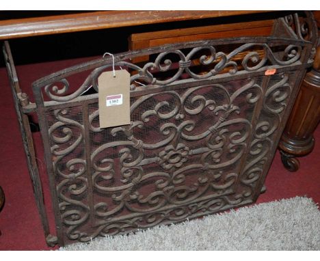 A pierced iron and mesh inset low triptych fireguard 