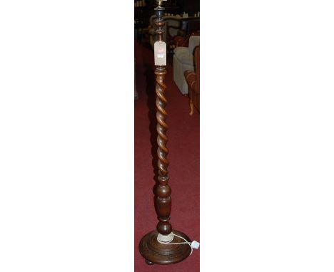 A 1930s oak standard lamp, having a barleytwist turned column, h.157cm (including fittings)