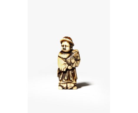 A JAPANESE STAG ANTLER NETSUKE EDO/MEIJI PERIOD Depicting a small child, karako, standing smiling and holding a large fightin