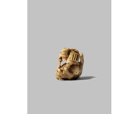 A JAPANESE BONE NETSUKE MEIJI 1868-1912 Depicting an armour-clad samurai, possibly Kato Kiyomasa, restraining a tiger beneath