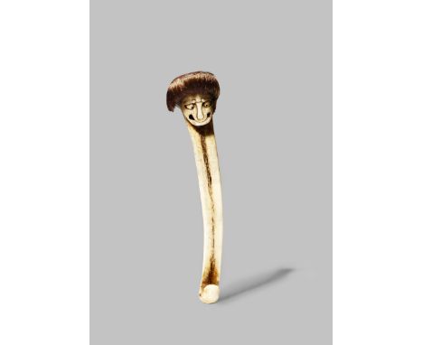 A JAPANESE ASAKUSA SCHOOL STAG ANTLER OBI-HASAMI NETSUKE MEIJI 1868-1912 Depicting a grimacing kappa, frowning and with cross