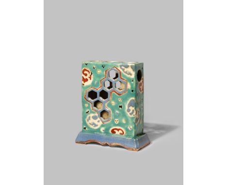 A JAPANESE KYOTO WARE JOSS STICK HOLDER EDO 1603-1868 The rectangular body decorated with abstract roundels in thick red and 