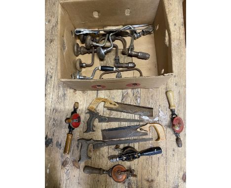 A box full of vintage tools including hand drills and antique saws, shipping unavailable 