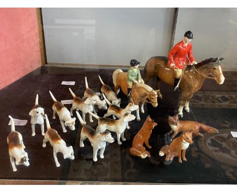 A Beswick hunting set including rider, dogs, foxes 