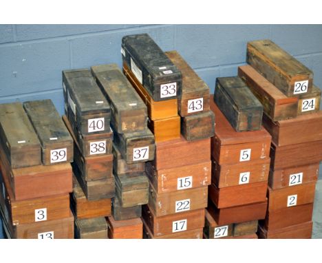 An extensive collection of early 20th Century glass magic lantern slides contained in fifty mahogany and other cases, hundred