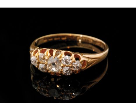 An early 20th Century 18ct hallmarked diamond seven stone boat shaped ring, old cut claw set stones, Birmingham 1903, ring si