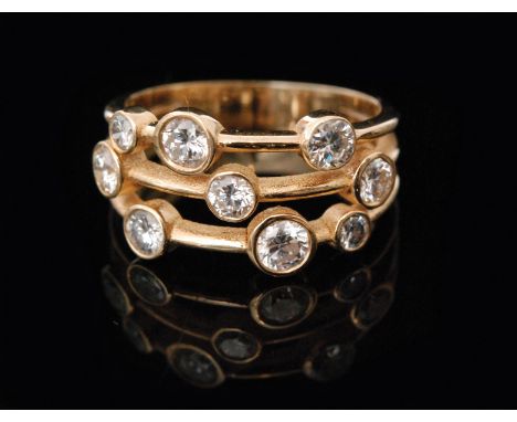 An 18ct diamond cluster ring, designed as three strands of yellow gold each highlighted by three graduated brilliant cut coll