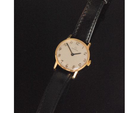 A 1970s 9ct Omega manual wind lady's wrist watch, the circular silvered dial with applied Arabic numerals, black baton hands,