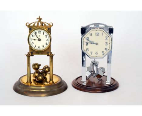 A 1920s 365-day mantle clock Arabic circular dial in a glass dome together with a similar mantle clock with cube chrome suspe