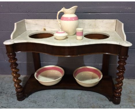 A Victorian mahogany white marble tray top washstand the serpentine front on spiral legs united by an undertier width 121cm t