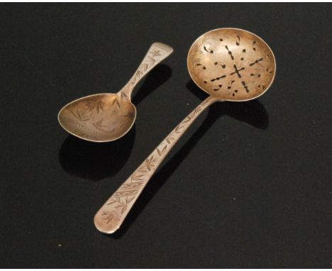 A hallmarked silver caddy spoon detailed with aesthetic engraved decoration to bowl and handle, together with a matching sift