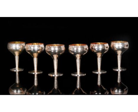 A set of six 1960s hallmarked silver wine goblets, each with plain cylindrical gilded bowl above textured tapering stem to pl