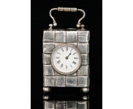 A George V hallmarked silver cased miniature carriage clock, the rectangular case of interwoven bamboo design with swing hand
