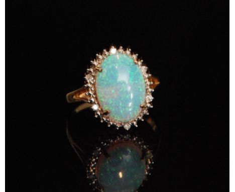 A modern 9ct hallmarked synthetic opal and diamond cluster ring, central opal within diamond surround, all stones claw set, r